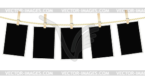 Photo frames hanging on rope with clothespins - vector clipart