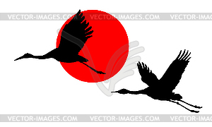 Cranes in sky on red sun - vector clipart