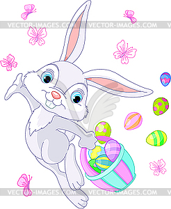 Easter Bunny Hiding Eggs - vector image