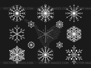 Christmas snowflakes on black background - vector clipart