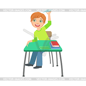 Schoolboy Sitting Behind Desk In School Class - vector clipart