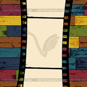 Film strip on colorful seamless wooden background.  - vector clip art