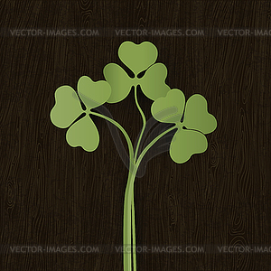 Clover leaves on wooden weathered texture. - vector clipart