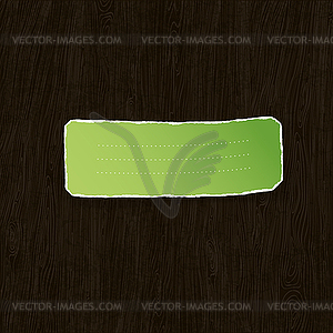 Green torn label on wooden texture. - color vector clipart