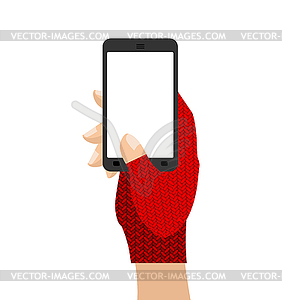 Hands in mittens hold phone. Winter gloves and - vector clipart