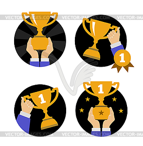 Hand holding golden trophy - vector clip art