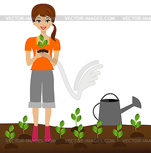 Молодая женщина растения питомник пересадку в почве - изображение в формате EPS