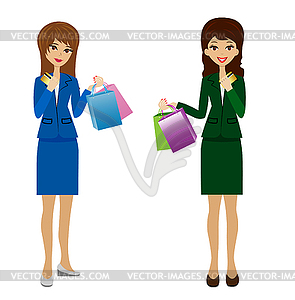 Two business women with credit cards and purchases - vector clipart