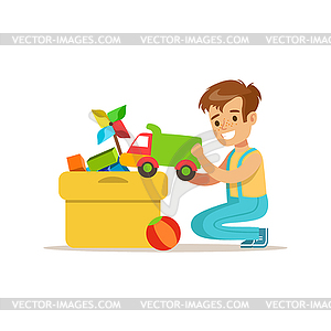 Boy Putting His Toys In Special Box Smiling - vector clipart