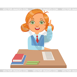 Cute schoolgirl sitting at desk and raising her han - vector image