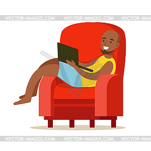 Happy young man sitting in red armchair and using - vector clip art