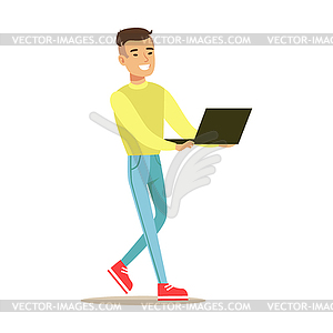 Young smiling man standing and using laptop. - vector clipart