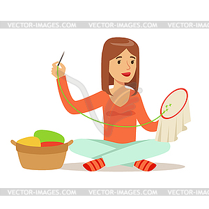 Young woman sitting on floor and embroidering - vector clip art