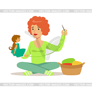 Young woman sitting on floor and sewing doll. - vector image