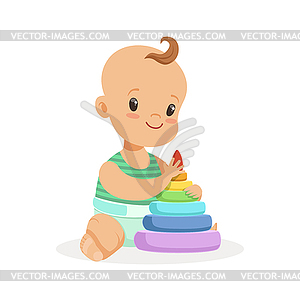 Cute smiling baby sitting and playing with pyramid - vector image