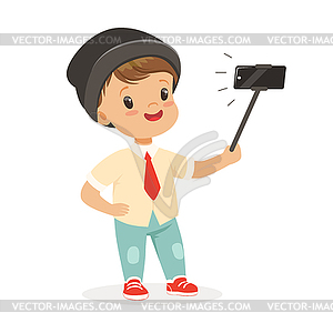 Cute little boy in fashionable clothes taking selfi - vector image