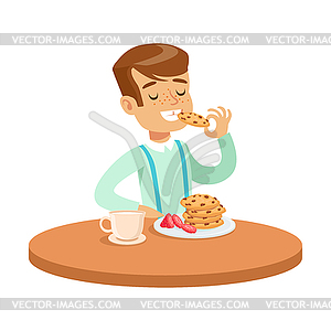 Happy boy sitting at table and eating cookies, - vector image