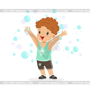 Happy redhead boy playing bubbles - vector image