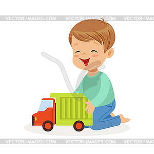 Cute happy little boy sitting on floor playing - stock vector clipart