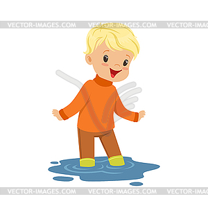 Cute blonde little boy playing on puddle wearing - vector image