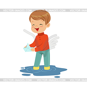 Cute little boy playing with paper boat in water - vector clip art