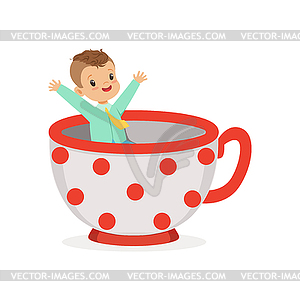 Cute little boy sitting in cup, kid have fun in - vector image