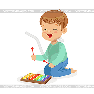 Cute little boy playing xylophone, young musician - vector image