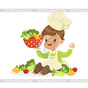 Cute little boy chef cooking fresh vegetables, - vector EPS clipart