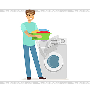 Young smiling man doing laundry, holding basin - vector clip art