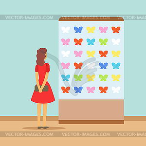 Young woman watching butterflies at exhibition in - vector image