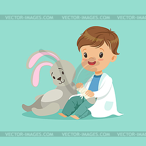 Cute baby boy heals paw of toy bunny. Little - vector clipart