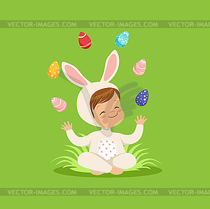 Cute little boy in bunny costume sitting on grass - vector clipart