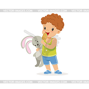 Очаровательны дошкольного мальчика проведения кролика игрушка и - векторный клипарт EPS