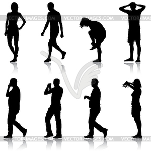 Black silhouette group of people standing in variou - vector image