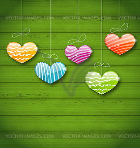 Colorful hearts hanging on green wooden texture - vector clip art