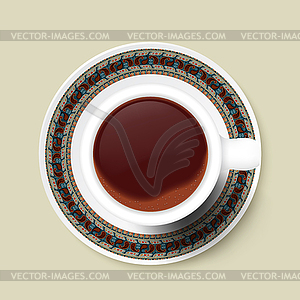 Cup of coffee and tribal texture on saucer. - vector image