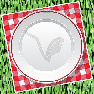 Red picnic tablecloth and empty plate on green grass - vector clipart