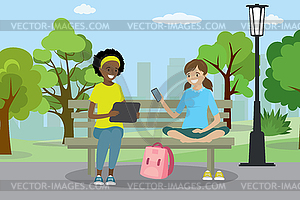 Две девочки-подростки с гаджетами сидят на скамейке - векторный клипарт