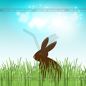 Chocolate bunny in green grass - vector clip art