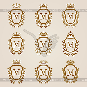 Golden shields with laurel wreath - vector image