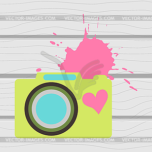 Old-fashioned color camera. Flat style. on wooden - vector image