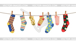Clothesline with socks and clothespins on rope - stock vector clipart