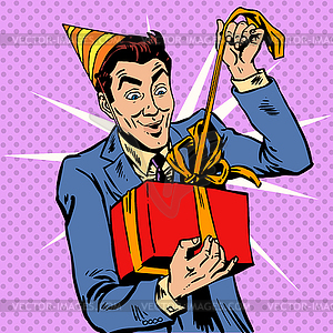 Male birthday unpacks gift - vector clipart