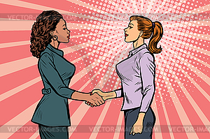 Two businesswomen shaking hands - vector clipart