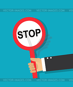 Hand holds a round stop sign - vector clipart