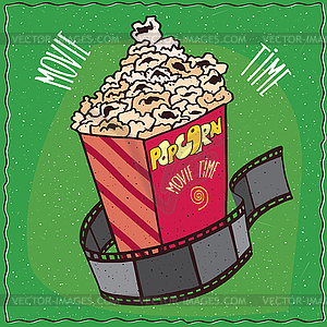Cardboard box with popcorn and reel of film - vector image
