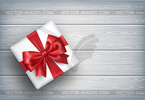 Настоящее Подарочная коробка с бантом на деревянный - клипарт в векторе / векторное изображение