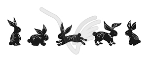 Set of rabbit silhouettes in different poses - vector image